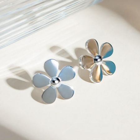 A pair of silver daisy stud earrings against a clean white background, ideal for product listings.