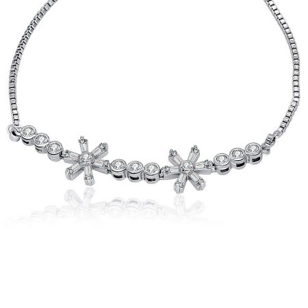 Detailed view of the CZ flower charms on the box chain bracelet, highlighting the bezel-set round cubic zirconia stones.