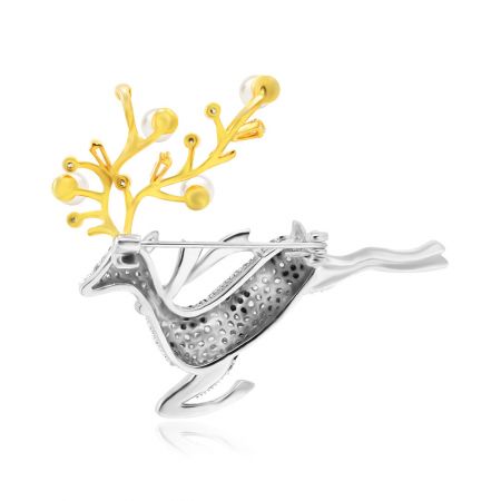 Un broche de joyería en forma de reno en tonos plateados y dorados, ideal para ocasiones festivas.