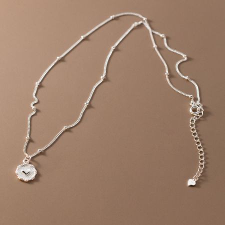 Side view of the sterling silver heart pendant necklace, showing the clasp and chain detail.