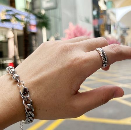 Model wearing the stainless steel wheat ring, showcasing its adjustable fit and style.