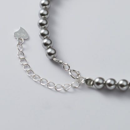 Customizable option shown with a leaf-shaped tag with 'M&K' initials on the silver bracelet.