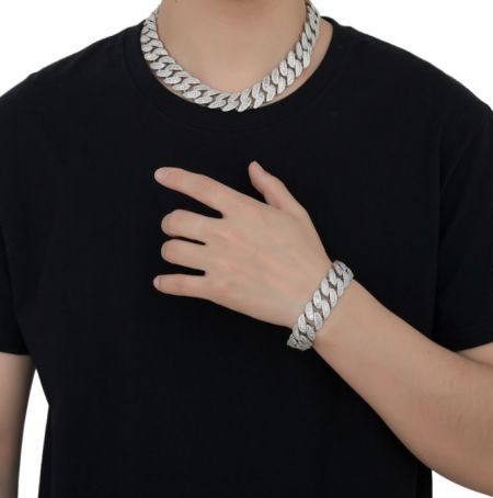 Model wearing a custom silver Cuban link chain necklace and matching bracelet.
