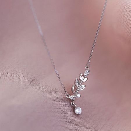 Alternative view of the silver leaf necklace showcasing its fine chain and pendant detail.