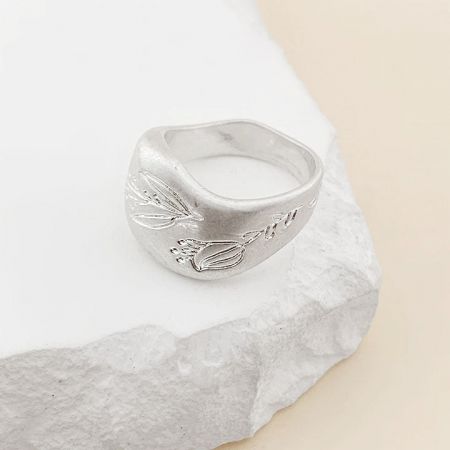 Another angle of the silver leaf-patterned chunky band ring.