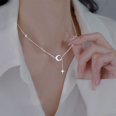 Another angle of the silver necklace highlighting the multiple star charms.