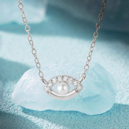 Clear view of the silver evil eye necklace pendant, highlighting the pearl and gemstones.
