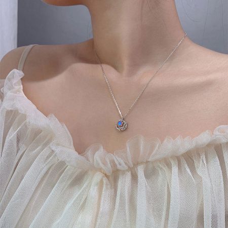 A sterling silver necklace showcasing a unique pendant with a mesmerizing blue and orange stone.
