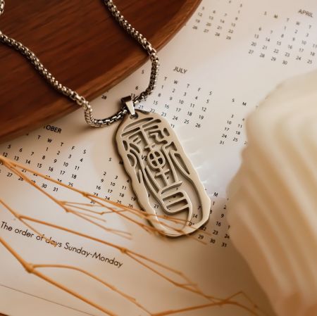 Customizable Chinese Symbols Necklaces - A custom silver necklace from JR Fashion Accessories, featuring an elegant oval pendant engraved with traditional Chinese symbols.