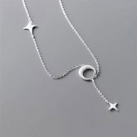 Close-up view of the celestial-themed pendants on the silver necklace.
