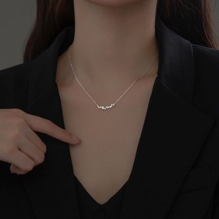 Detailed view of the 925 sterling silver smile choker necklace with a cluster of sparkling cubic zirconia.