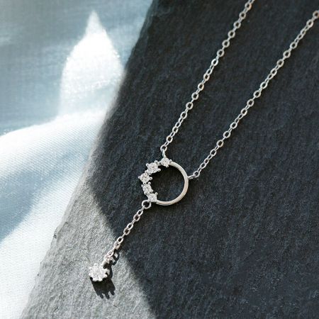 Close-up detail of the sterling silver tassel pendant necklace, highlighting the sparkling zircon stones.
