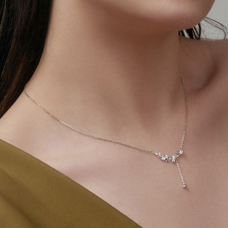 Model shot showcasing the silver leaf tassel necklace, demonstrating its length and how it complements an outfit.
