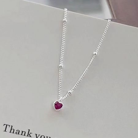 The ruby heart zircon necklace displayed on a 'Thank you' card, perfect for gifting.