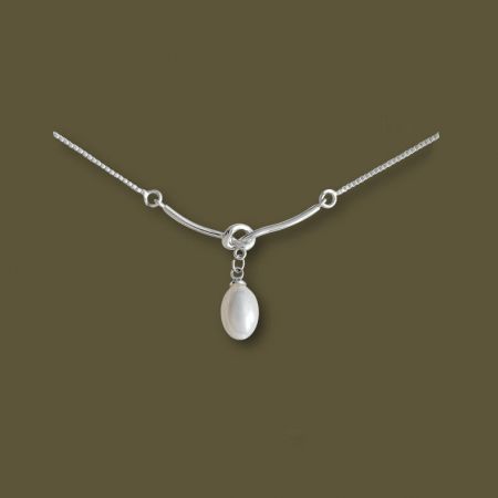 The silver necklace with its white pearl-like pendant, showcasing its minimalist appeal.