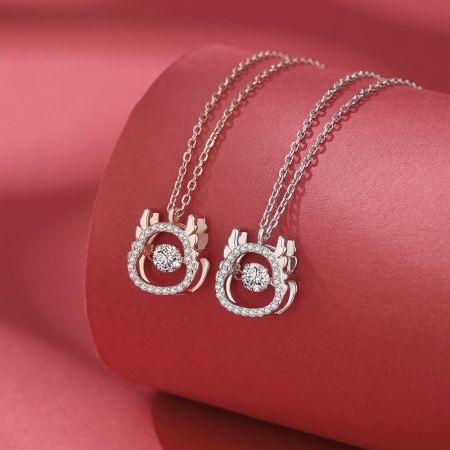 Close-up of the two dragon pendant necklaces, showing the craftsmanship of the sterling silver.
