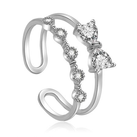 Love Adjustable Bow Ring - A close-up of the Love Adjustable Bow Ring, showcasing its rhodium-plated brass band and intricate bow design set with sparkling white cubic zirconia stones.