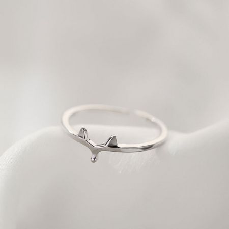 Close-up of a sterling silver ring featuring an artistic whale design.
