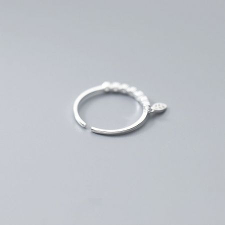 A 925 sterling silver ring with a dangling leaf charm, shown from a different angle.