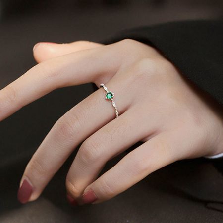 Model wearing the elegant 925 sterling silver ring with a green gemstone.