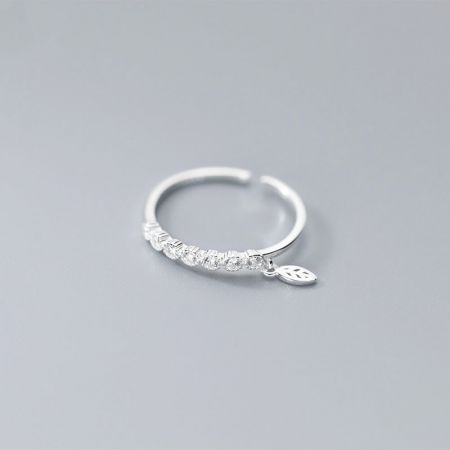 Detailed view of the sterling silver ring highlighting the leaf charm and cubic zirconia stone.