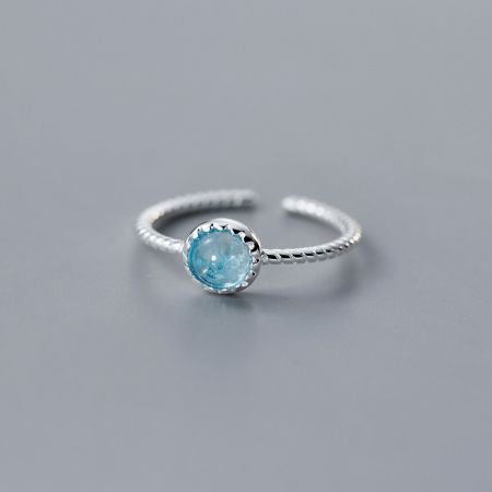 A sterling silver open ring featuring a beautiful light blue aquamarine gemstone.