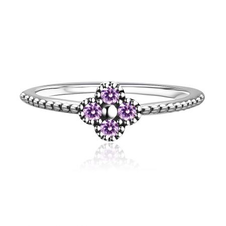 Side view of the sterling silver ring featuring brilliant purple cubic zirconia stones.
