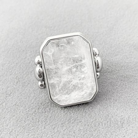 Close-up of a silver-finished ring featuring a prominent rectangular crystal.