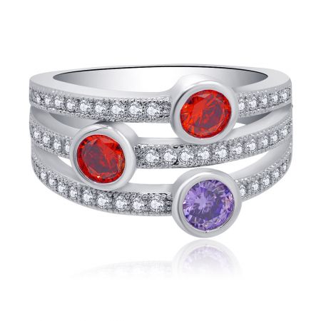 Side view of the multi-gemstone ring showcasing two red and one purple bezel-set stones on a layered silver band with small diamonds.