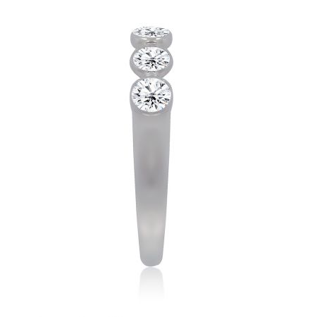 Angled shot of the Bezel Set Stackable Band Ring on a white background.