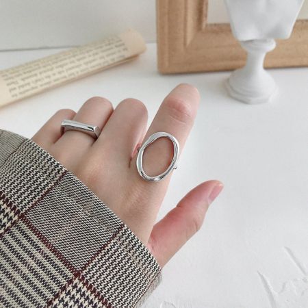 A model's hand wearing the adjustable 925 silver oval open rings, showcasing their elegant fit.