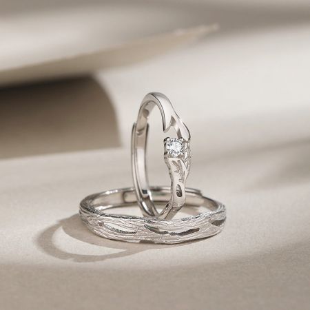 Product shot of the two unique sterling silver rings, one featuring a sparkling diamond.