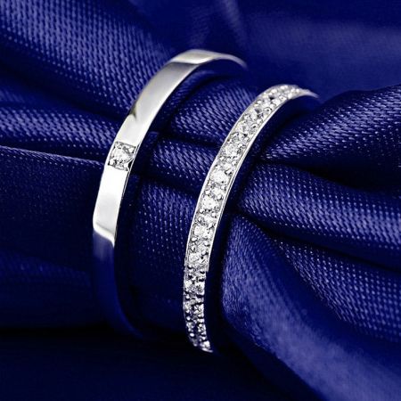 Elegant display of the CZ silver couples rings on a deep blue textile.