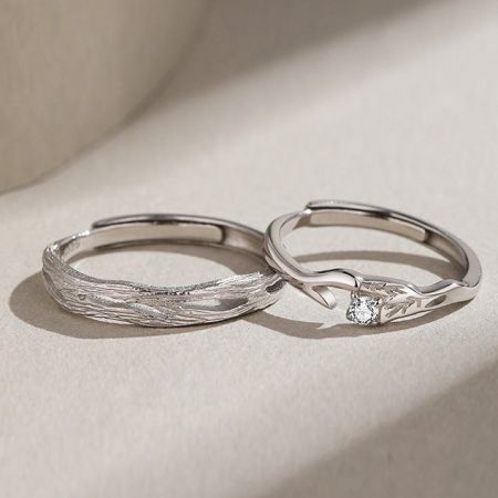 Close-up detail of the woven texture and diamond accent on the sterling silver couple rings.