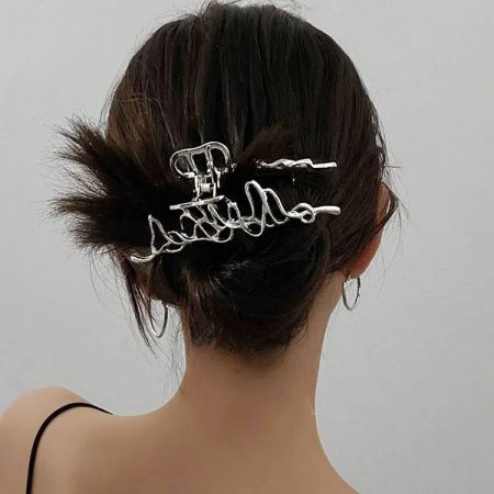 A model showcasing the large silver geometric hair clip in her hair.