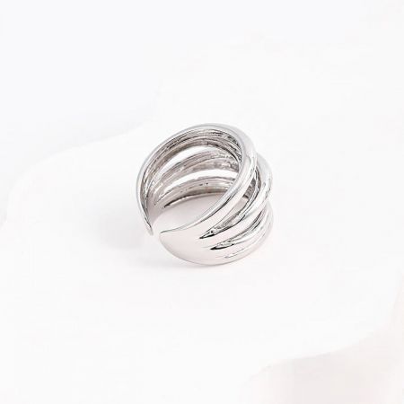 Detailed view of a silver ring from the set, showcasing its intricate spiral design.