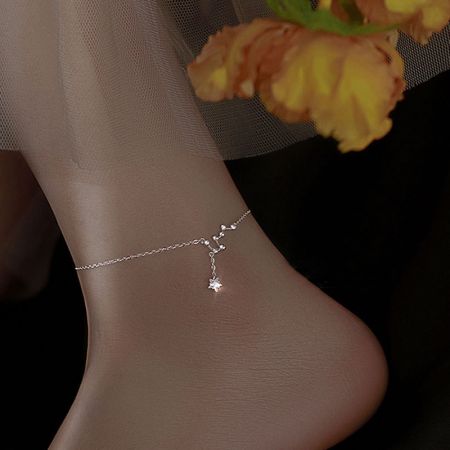 Close-up of the 925 silver star charm anklet worn on an ankle, showcasing its delicate chain.