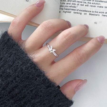 Een model met de minimalistische 925 zilveren vlinder ring, die de elegante en verstelbare pasvorm voor dagelijks gebruik toont.