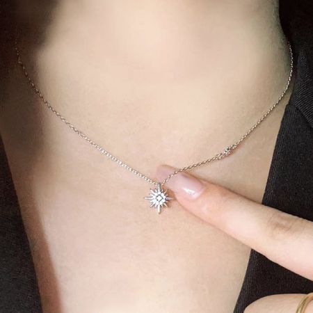 Model wearing the sterling silver starburst double sun necklace, highlighting its length and style.