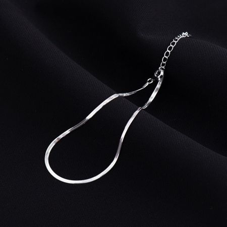Flat lay of the 925 silver snake chain anklet set, showcasing the platinum and gold-tone options.
