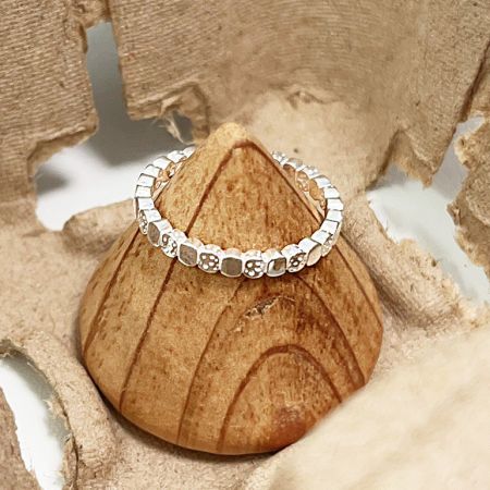 Detailed view of a sterling silver open ring with a unique textured square brick pattern.