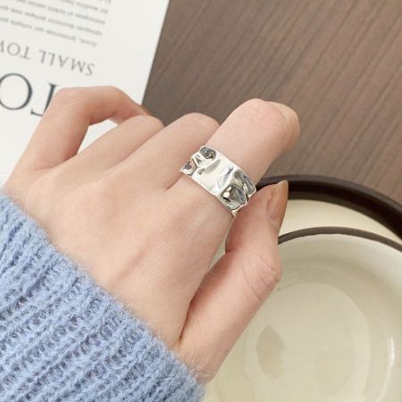 Top-down view of a silver textured geometric ring.