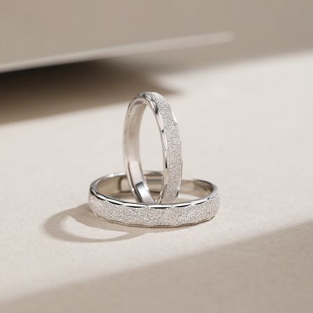 Detailed shot of the sterling silver promise rings, showcasing the unique sanded finish.