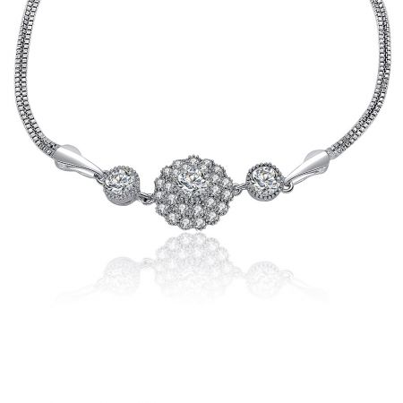 Close-up view of the CZ sunburst charm on the box snake chain bracelet, highlighting the intricate gemstone setting.
