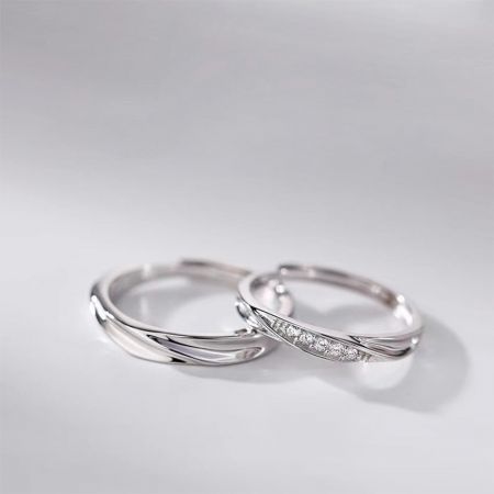 Close-up of the matching silver rings, highlighting the polished and pavé cubic zirconia bands.