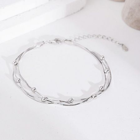 Close-up of the twisted layers and spherical beads of the 925 silver bracelet.