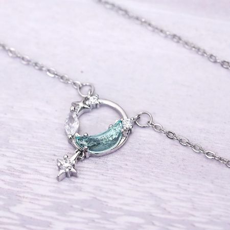 Unique silver necklace with a wave-like pendant and a dangling star charm.