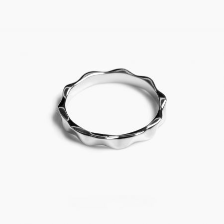 The platinum plated version of the wavy band ring, displaying its cool-toned metallic sheen and unique shape.
