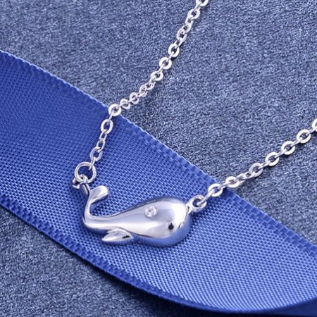 Close-up view of the sterling silver whale pendant.