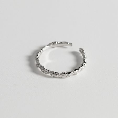 Side profile of the silver braided ring, showing the depth of the woven design.